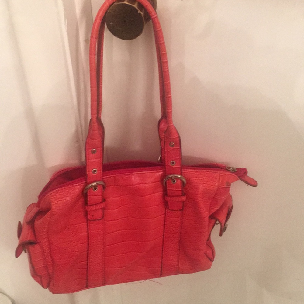 Red handbag with different compartment inside and out.